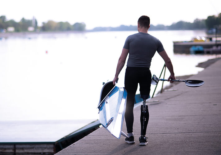 man carrying canoe